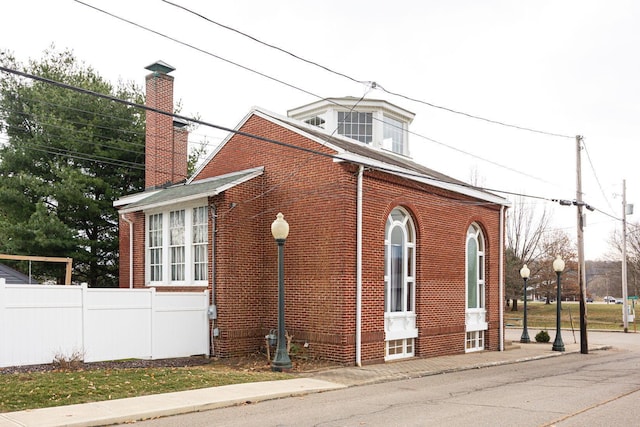 108 W Main St, Glenford, OH 43739 - view of home's exterior with brick siding, a chimney, and fence