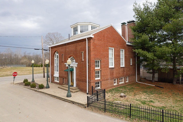 108 W Main St, Glenford, OH 43739 - view of side of property featuring fence, a chimney, brick siding, and entry steps