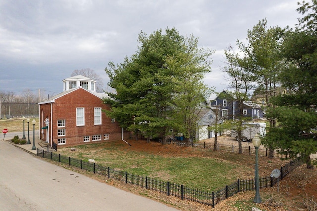 108 W Main St, Glenford, OH 43739 - view of home's exterior featuring a lawn, brick siding, and fence