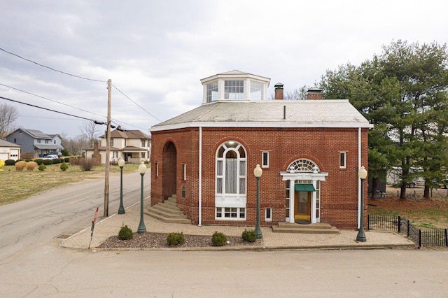 108 W Main St, Glenford, OH 43739 - view of front facade featuring brick siding, a chimney, and fence