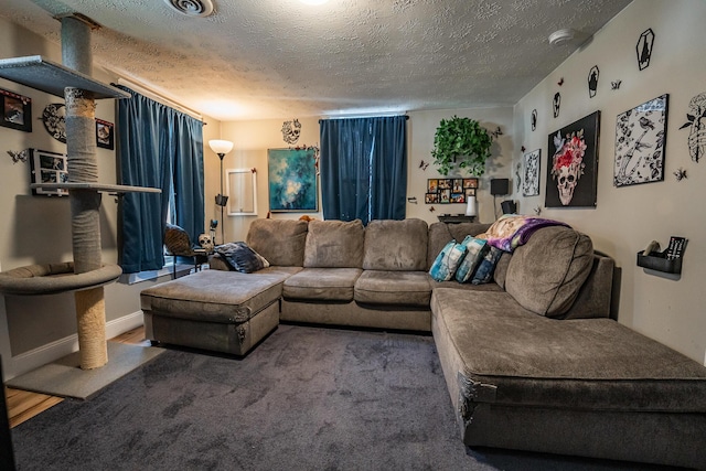 carpeted living area featuring visible vents and a textured ceiling