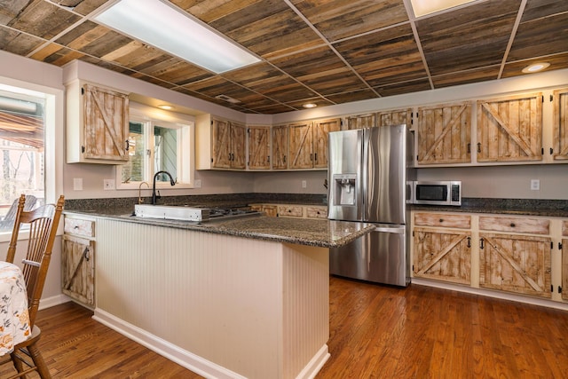 kitchen featuring dark wood-style floors, a peninsula, wooden ceiling, and appliances with stainless steel finishes