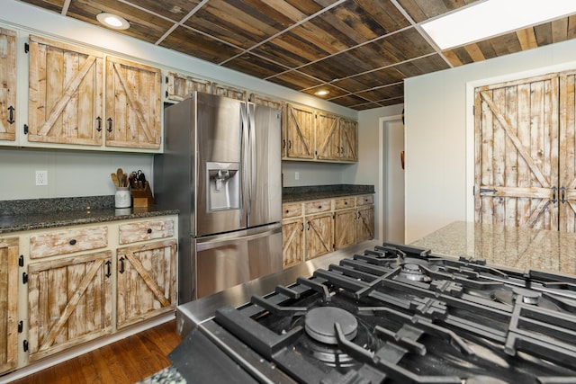 kitchen with cooktop, dark stone counters, wood ceiling, stainless steel fridge with ice dispenser, and dark wood-type flooring