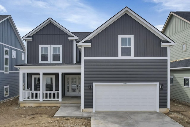 view of front of property featuring an attached garage, covered porch, concrete driveway, and board and batten siding