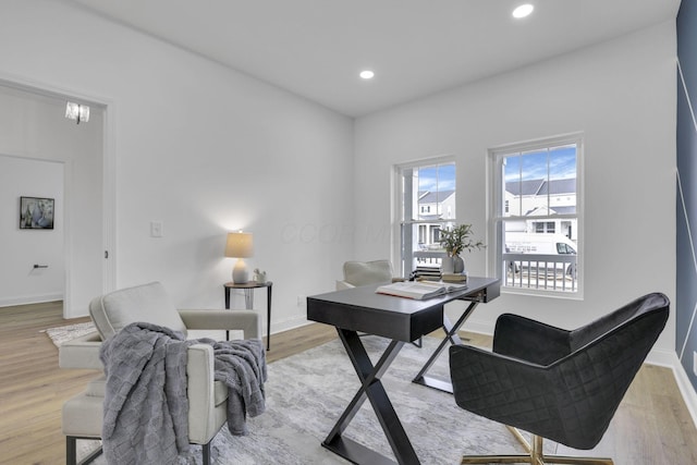 office space with baseboards, light wood finished floors, and recessed lighting