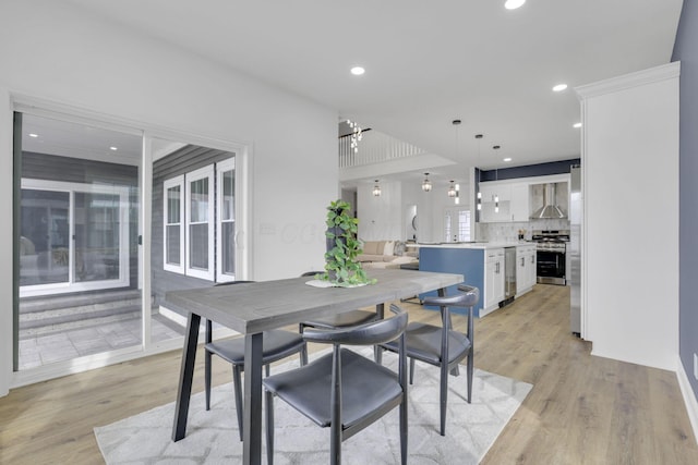 dining room with light wood-style flooring and recessed lighting