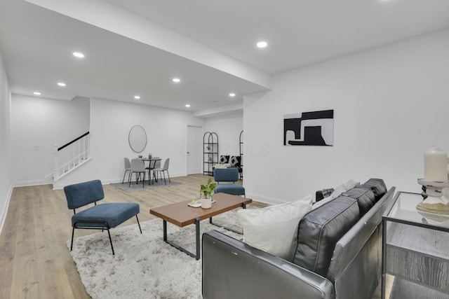 living room featuring baseboards, recessed lighting, wood finished floors, and stairway