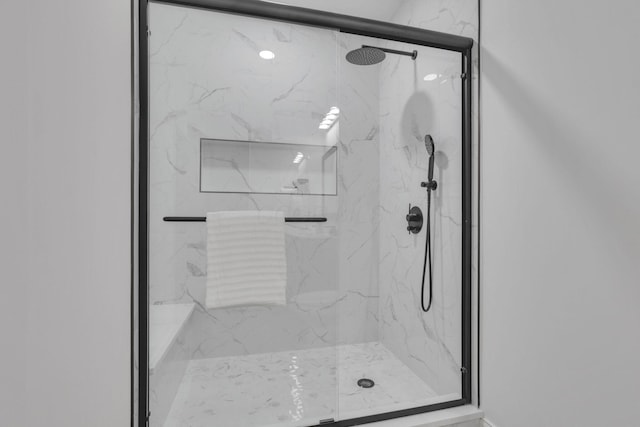 full bathroom featuring a marble finish shower
