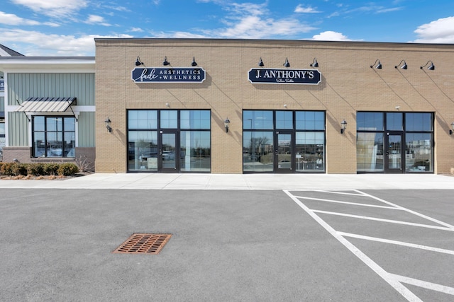 view of building exterior featuring uncovered parking