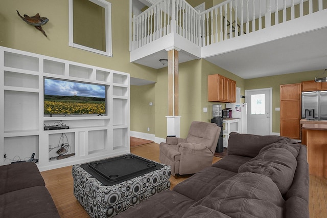 19643 Big Pine Rd, Laurelville, OH 43135 - living room featuring built in features, decorative columns, baseboards, and wood finished floors