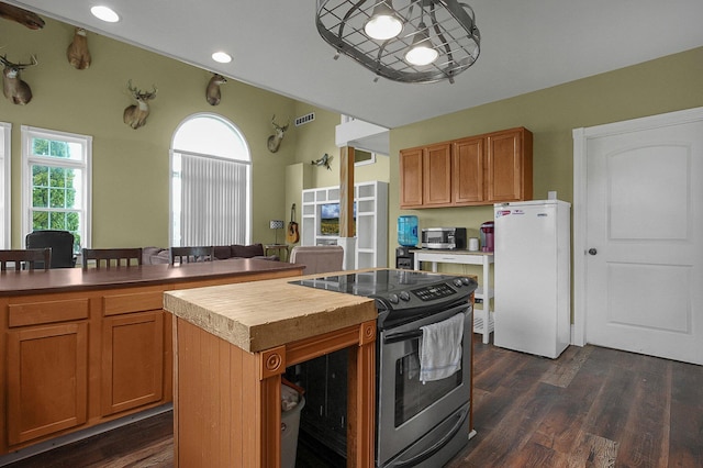 19643 Big Pine Rd, Laurelville, OH 43135 - kitchen with visible vents, a kitchen island, dark wood-type flooring, butcher block countertops, and stainless steel appliances