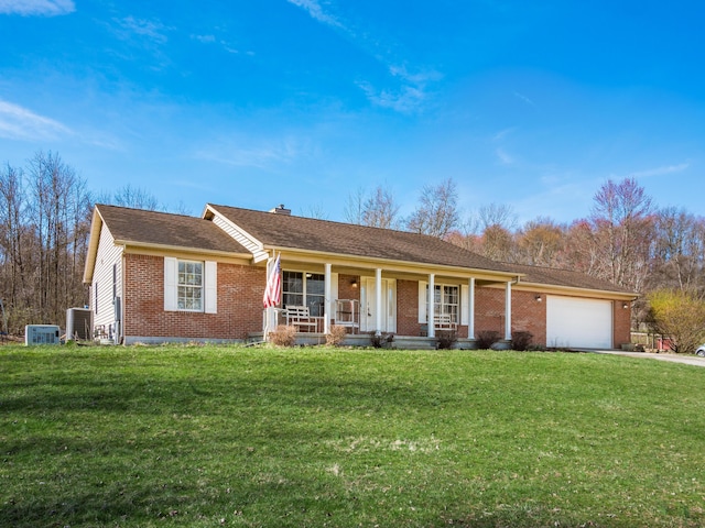 single story home featuring central air condition unit, a front yard, covered porch, and an attached garage
