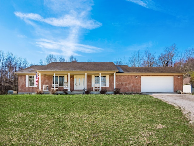ranch-style house featuring driveway, a front lawn, a porch, a garage, and brick siding