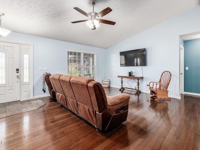 living room featuring a textured ceiling, wood-type flooring, and vaulted ceiling
