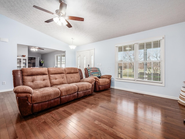 living area with dark wood finished floors, visible vents, a textured ceiling, and ceiling fan