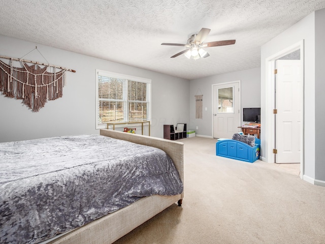 bedroom featuring a textured ceiling, carpet, baseboards, and ceiling fan