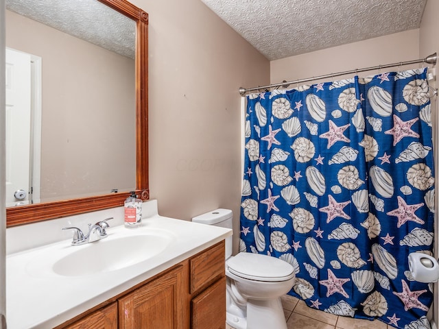 bathroom featuring vanity, tile patterned flooring, a textured ceiling, curtained shower, and toilet
