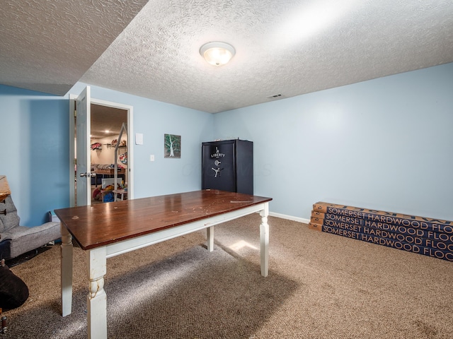 office with visible vents, a textured ceiling, baseboards, and carpet