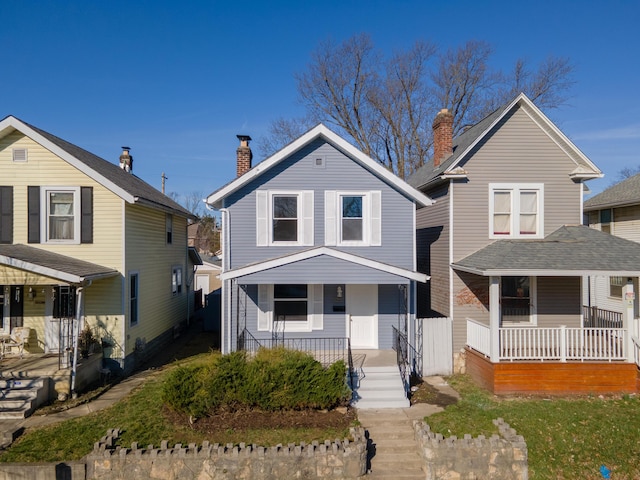 traditional home with a porch and a chimney