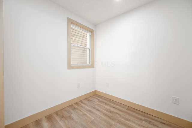 empty room with light wood-style floors and baseboards