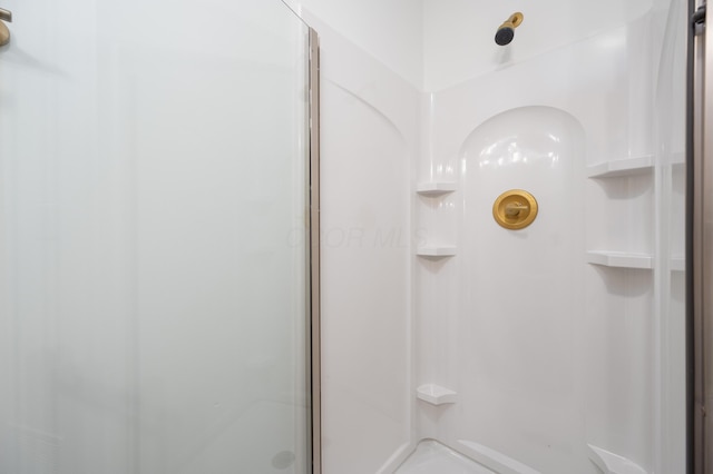 full bath featuring a shower stall