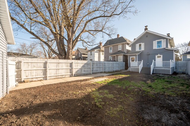 view of yard with a fenced backyard and a residential view