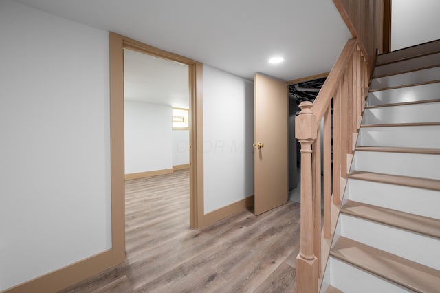 staircase with recessed lighting, baseboards, and wood finished floors