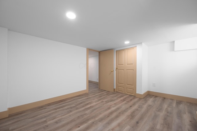 finished basement featuring recessed lighting, baseboards, and wood finished floors