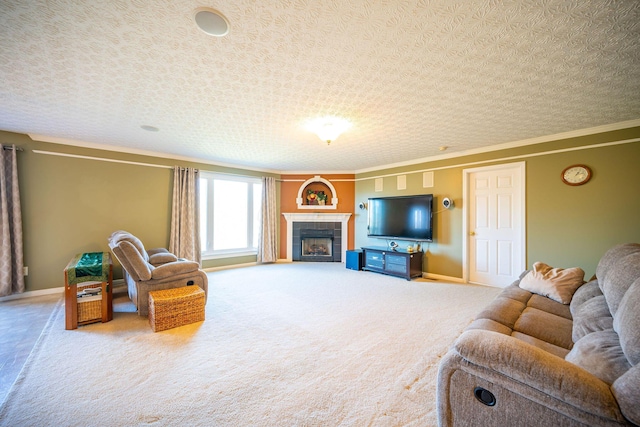 carpeted living area featuring crown molding, a tiled fireplace, baseboards, and a textured ceiling