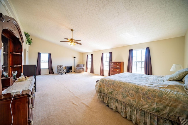 carpeted bedroom featuring ceiling fan, a textured ceiling, and lofted ceiling