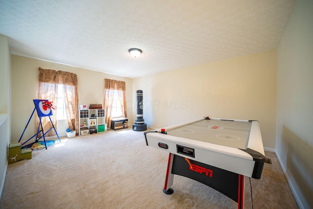 game room with a textured ceiling, baseboards, and carpet floors