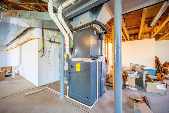 utility room featuring heating unit