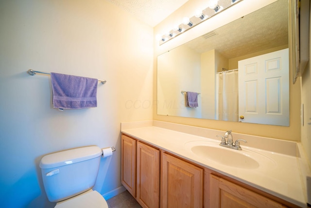 bathroom with visible vents, baseboards, toilet, a textured ceiling, and vanity