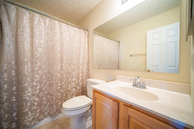 bathroom featuring toilet, a textured ceiling, and vanity