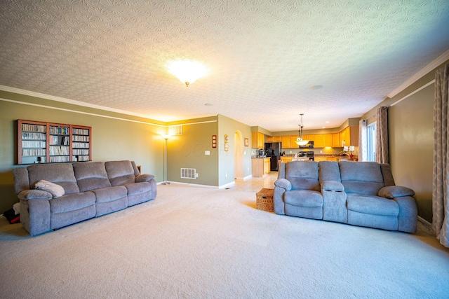 living room with baseboards, ornamental molding, light carpet, a textured ceiling, and visible vents