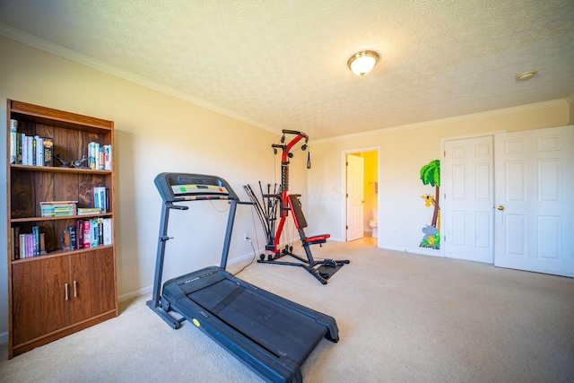 workout room with baseboards, a textured ceiling, ornamental molding, and carpet floors