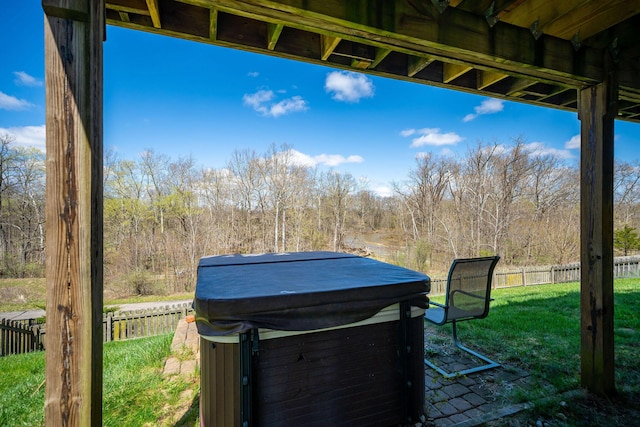 view of patio with fence and a hot tub