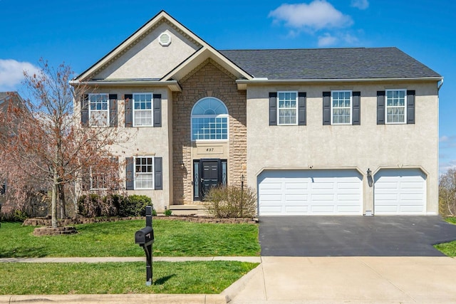 view of front of property with a front yard, stucco siding, and an attached garage