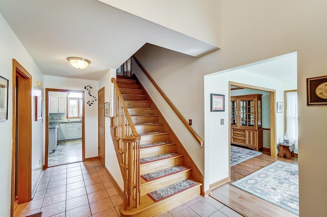stairs featuring baseboards and wood finished floors