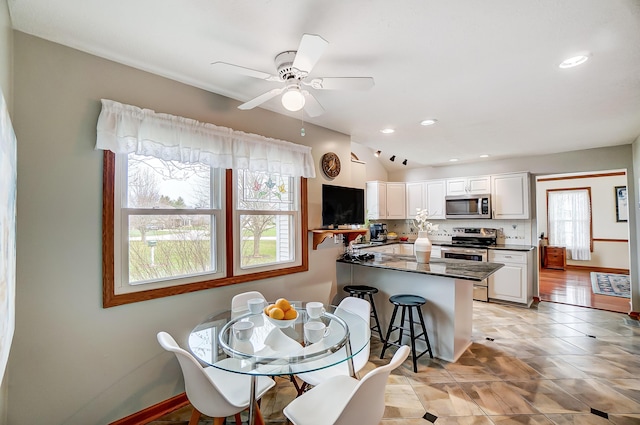 dining area with baseboards, ceiling fan, recessed lighting, and light tile patterned floors