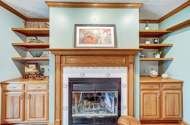 room details with a textured ceiling, a fireplace, and ornamental molding