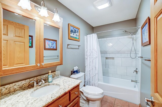 full bathroom with vanity, toilet, tile patterned flooring, and shower / bathtub combination with curtain