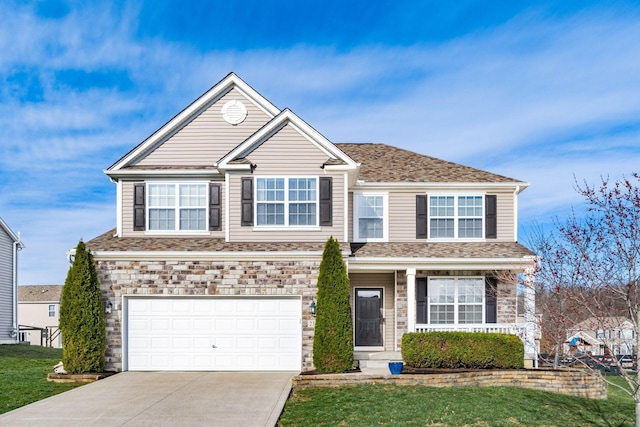 traditional-style house featuring stone siding, concrete driveway, a garage, and a front lawn