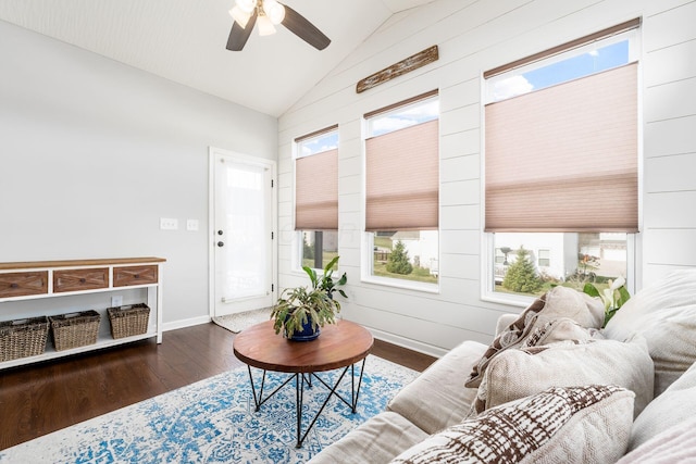 living area featuring a ceiling fan, baseboards, lofted ceiling, and wood finished floors
