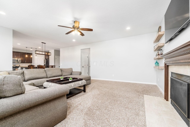 living area with a tiled fireplace, light carpet, baseboards, ceiling fan, and recessed lighting