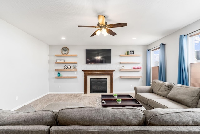 living room featuring carpet, a glass covered fireplace, baseboards, ceiling fan, and recessed lighting