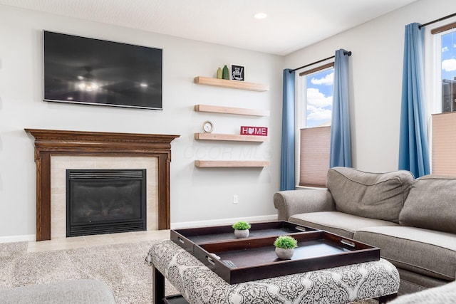 living room with baseboards, recessed lighting, and a tiled fireplace
