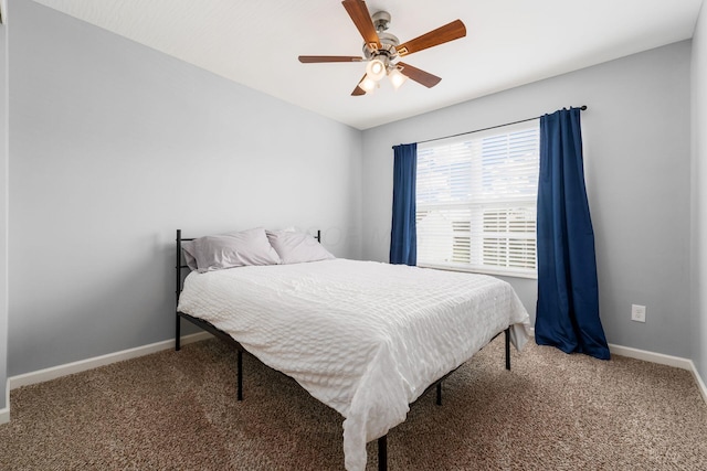 bedroom with baseboards, ceiling fan, and carpet