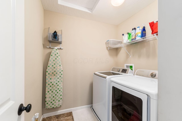laundry room featuring baseboards, washing machine and dryer, and laundry area