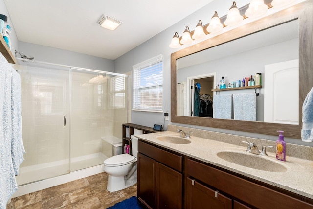 bathroom featuring a sink and a shower stall